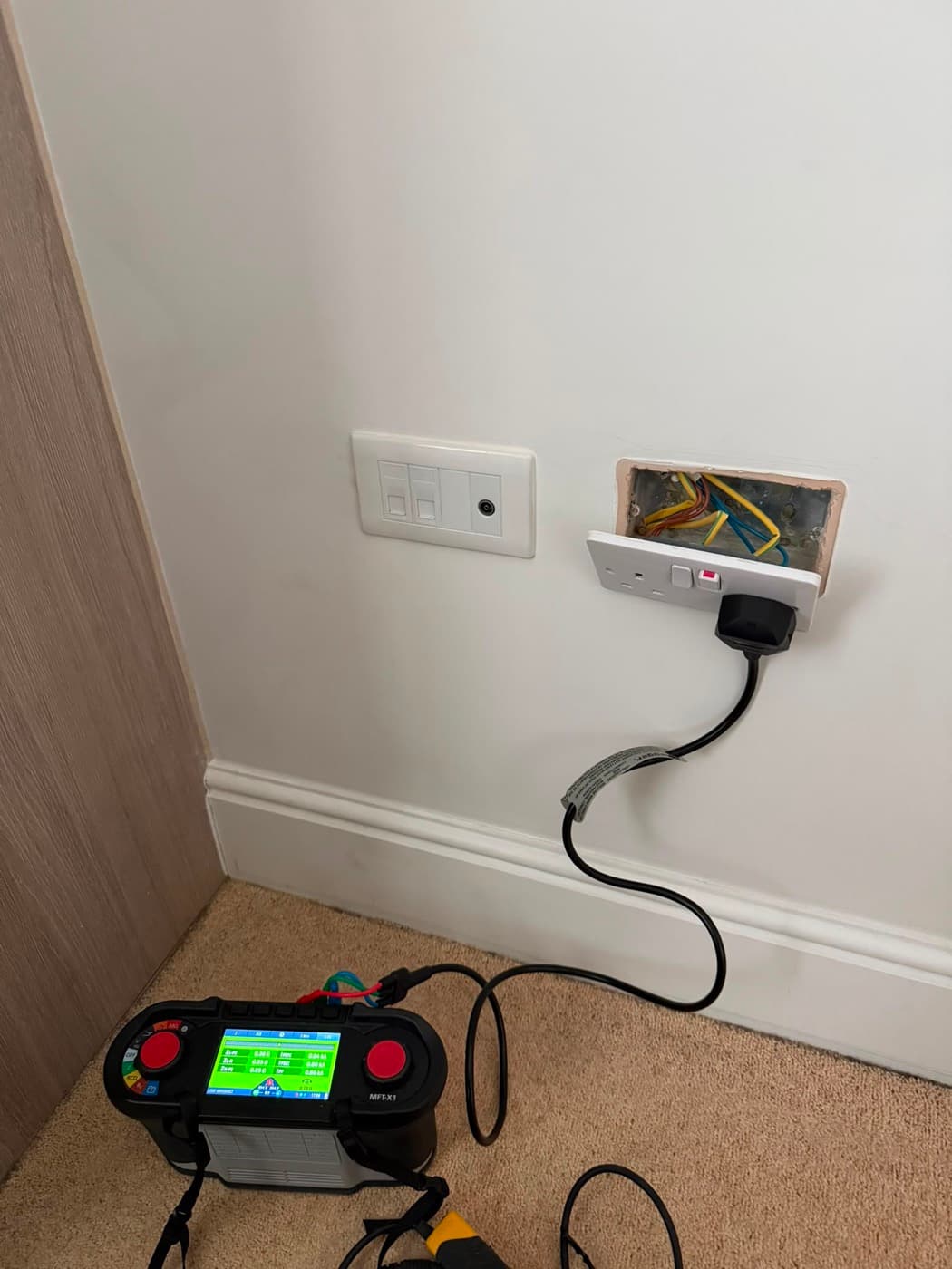 Multifunction tester connected to a socket circuit during fault finding