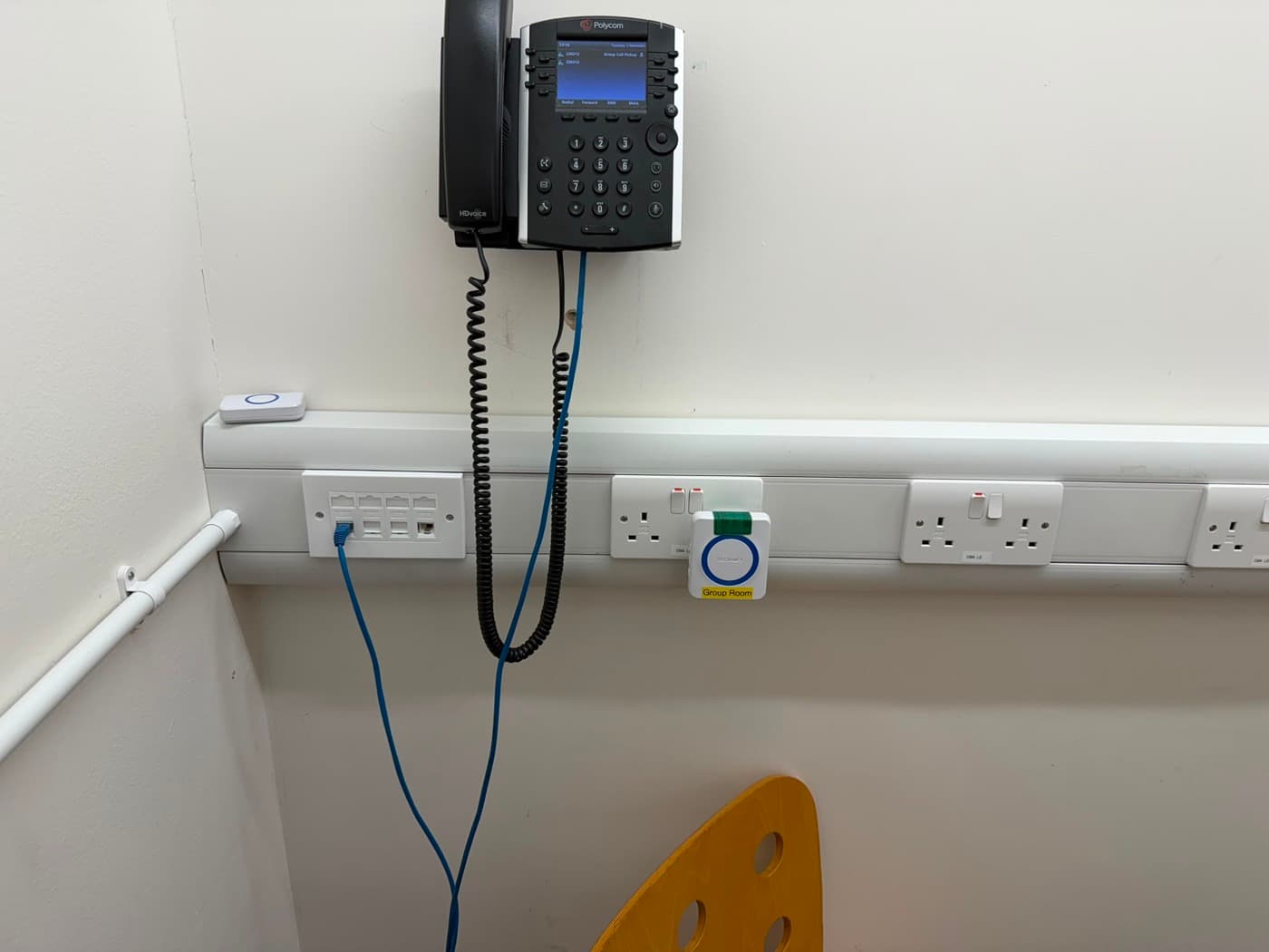 Dado trunking with sockets, data points and a desk phone in an office