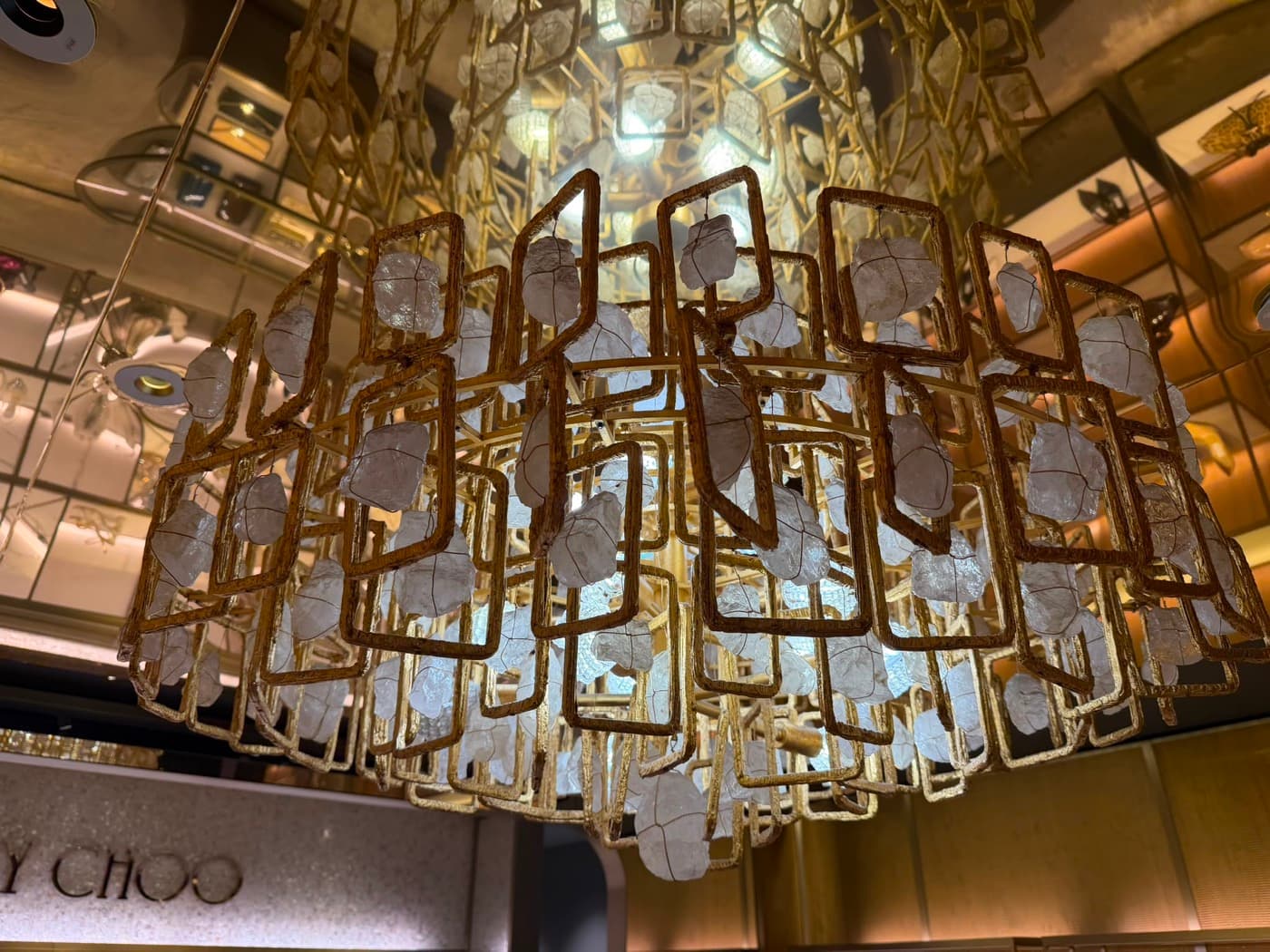 Large gold and crystal chandelier fitted in a retail store